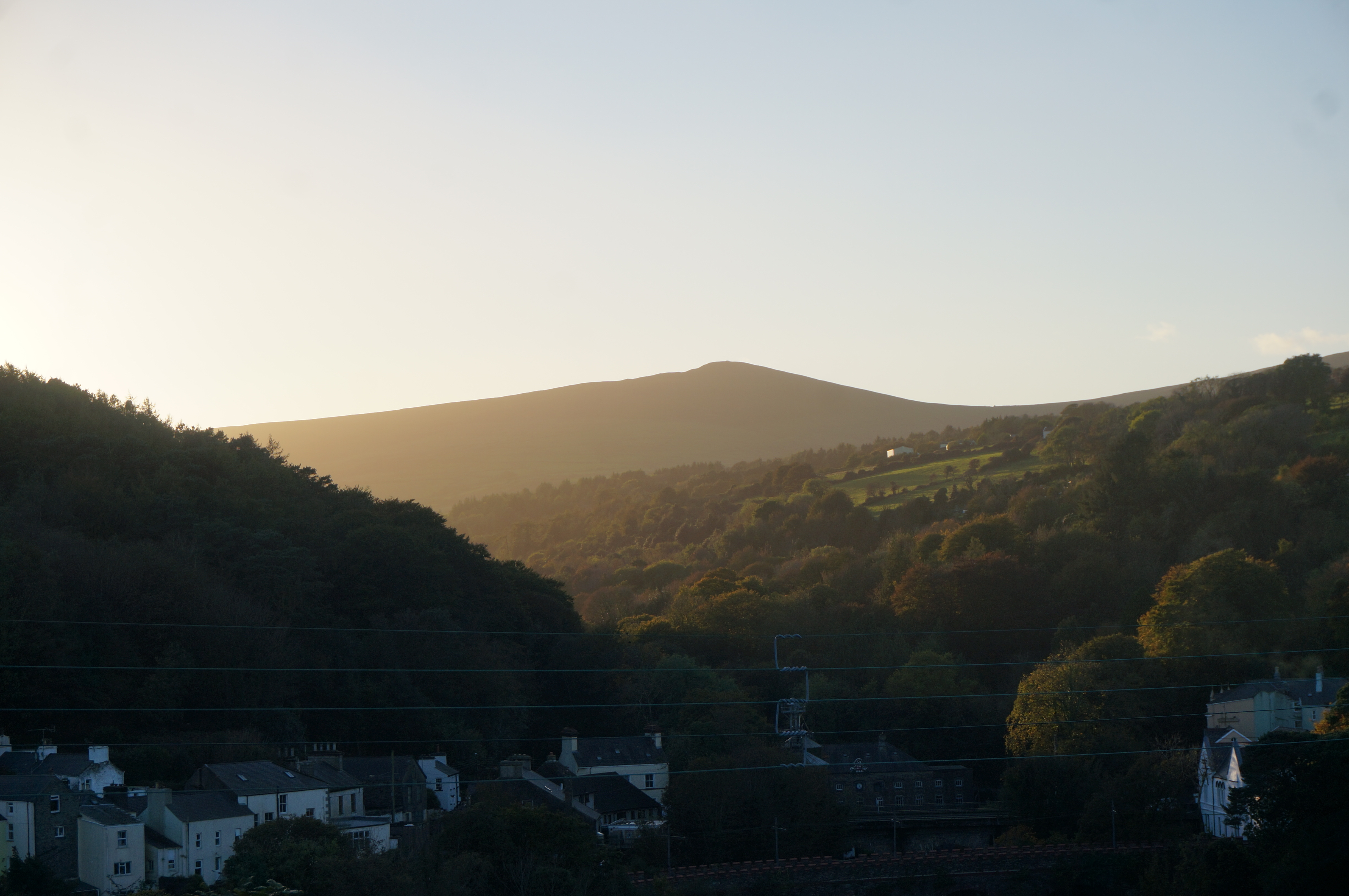 The view up the valley to the hills from our Isle of Man house as the sun sets on the west side of the island